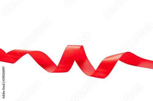 Red satin ribbon wavy isolated cutout on white background