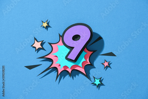 Paper cut with number 9 on speech bubble.