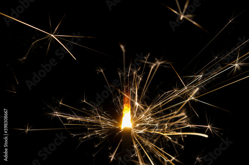 Extreme close-up of a burning sparkler with black background 