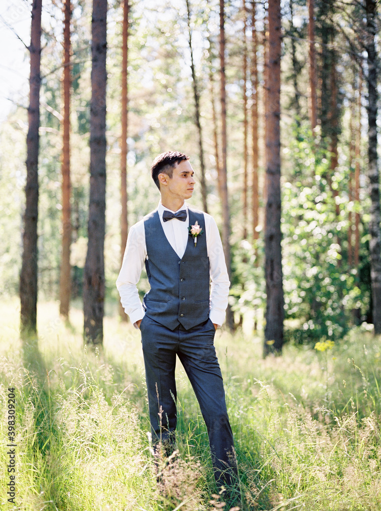 Groom standing in park Groom standing in park