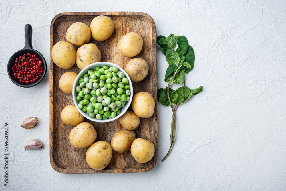 Mashed potatoes ingredients with green pea and mint, flat lay, on white textured background  with space for text