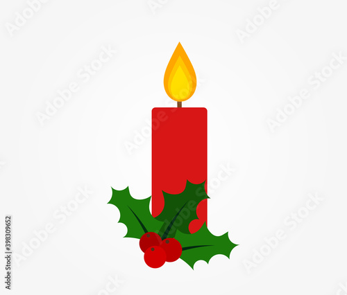 Christmas red candle and holly berries.