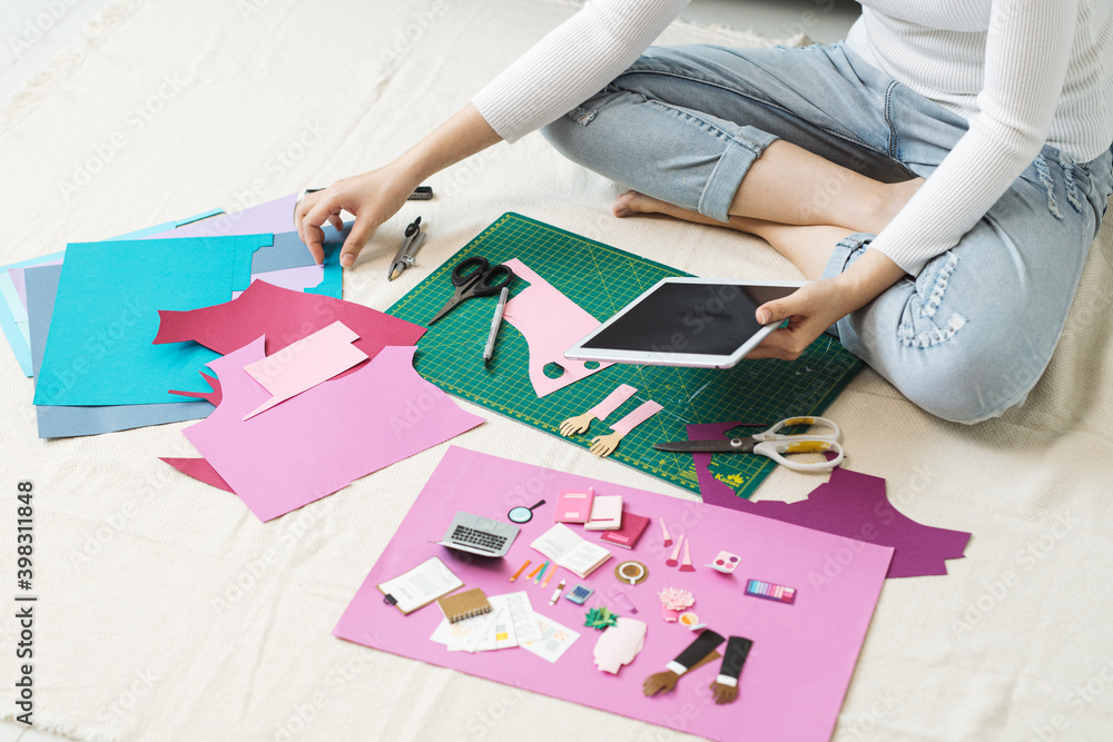 © Maki Company Limited/Stocksy - Artist doing paper craft. © Maki Company Limited/Stocksy - Artist doing paper craft.