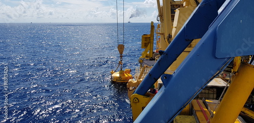 a crane lifts a pile during offshore construction operation photo