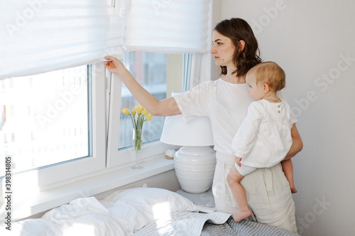 Mother standing with baby on her hands