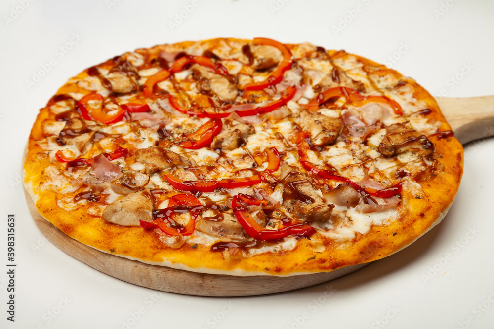 Delicious pizza with bacon and chicken Teriyaki served on a wooden plate, ingredients Signature sauce, mozzarella cheese, Teriyaki chicken, bacon, Bulgarian pepper, Teriyaki sauce on white Delicious pizza with bacon and chicken Teriyaki served on a wooden plate, ingredients Signature sauce, mozzarella cheese, Teriyaki chicken, bacon, Bulgarian pepper, Teriyaki sauce on white