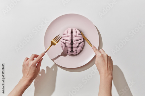 Plate with human brain ahd women's hands. photo