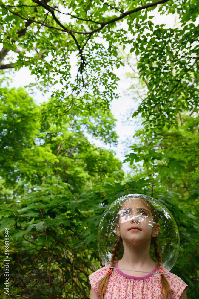 Little Girl Outdoors Wearing Bubble on Head Little Girl Outdoors Wearing Bubble on Head