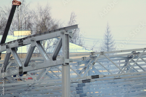 An old steel metal farm. structure of metal structure of frame-type industrial building. Lightweight metal frame construction.