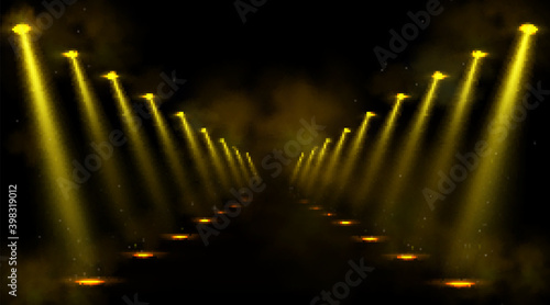 Corridor illuminated by spotlights. Empty road or gallery with yellow beams of lamps and spots of light on floor. Vector realistic interior of dark hall, studio or theater stage with projectors rays
