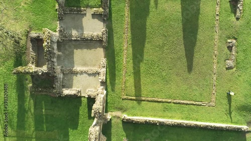 Basingwerk abbey landmark medieval abandoned Welsh ruins Aerial view birdseye rising shot photo