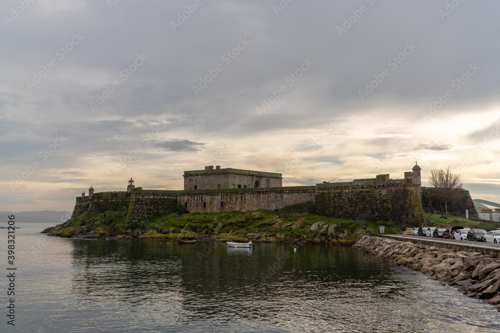 view of the Castelo de San Anton fortress in the harbor of La Coruna in Galicia
