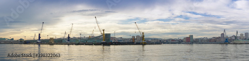 a panorama view of the industrial port and harbor in La Coruna in golden morning light