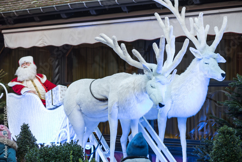 Reindeer are carrying Santa Claus. White toy deer for the exhibition.  Christmas and New Years Eve.