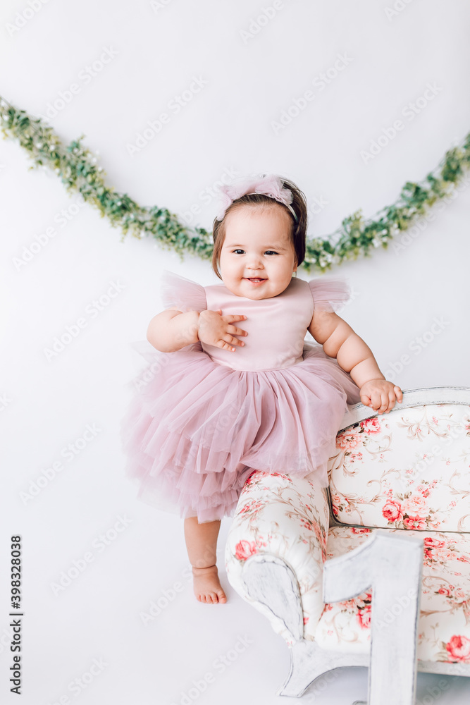 Little girl baby in a beautiful dress with the number 1 Little girl baby in a beautiful dress with the number 1