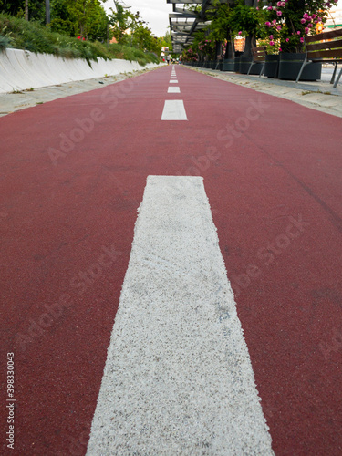 Red bycicle asphalt road in summer town