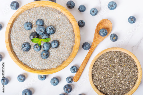 chia pudding with blueberries in a wooden plate