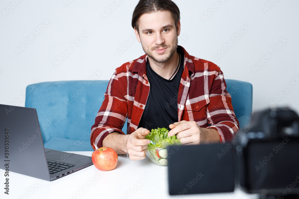 Social media influencers or content maker concept. Guy recording video on camera and expresses emotions. Healthy lifestyle. Social media influencers or content maker concept. Guy recording video on camera and expresses emotions. Healthy lifestyle.