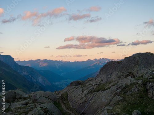Evening sunset summer view of Stubai valley from Bremer Hutte at hiking trail, Stubai Hohenweg, rock, boulders and moutain peaks. Tyrol Alps, Austria