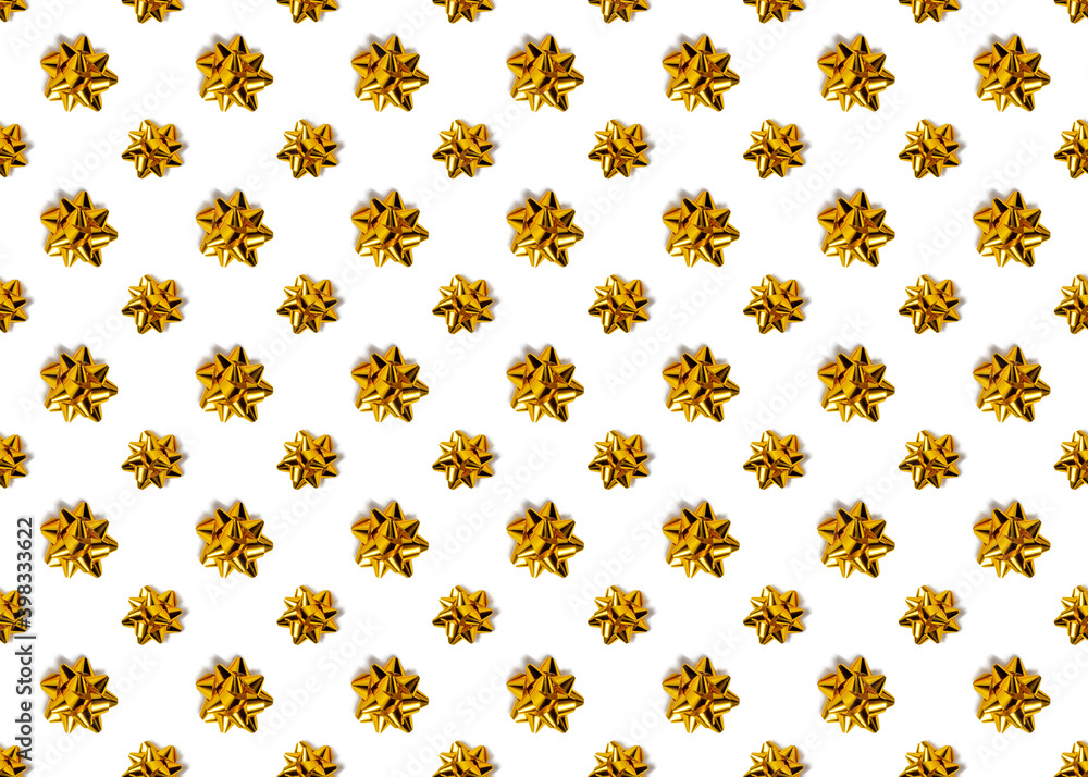 seamless colorful pattern of large and small gold bows. trending christmas. view from above. isolated