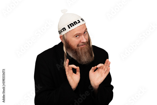 Obraz na płótnie Studio portrait of bearded orthodox jewish man. Cheerful smiling charismatic jew with sidelocks in white yarmulke isolated on white background. w salonie