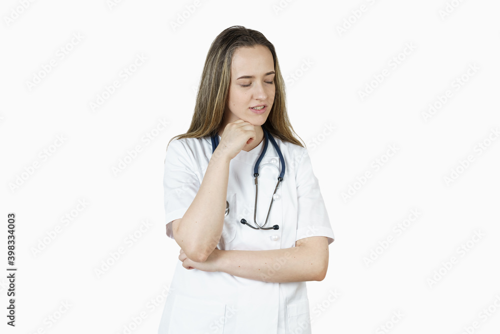 Medicine and health concept. A young woman doctor is thinking, dreaming. Medicine and health concept. A young woman doctor is thinking, dreaming.