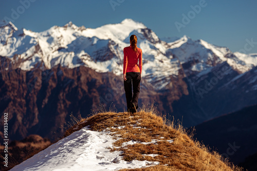 woman on top of a mountain observes the view © criskorah