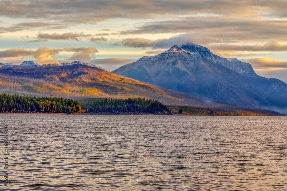 Autumn scene of colorful mountains and clouds on the shore of Lake McDonald, Glacier National Park, Montana