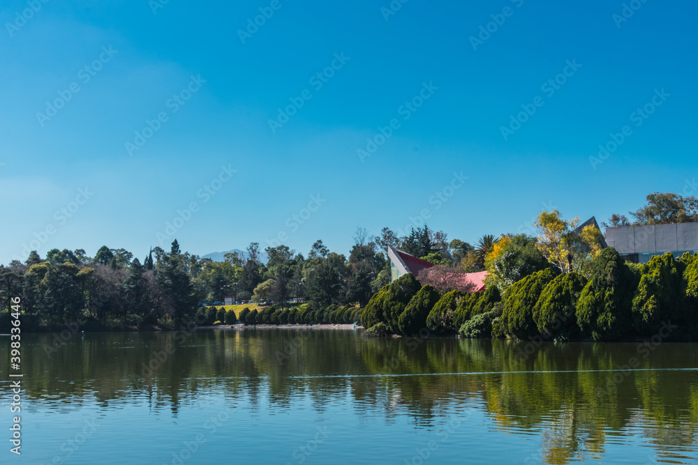 A beautiful view of a lake on a sunny day. A view of Bosque de Chapultepec, the biggest park in Mexico City and one of the biggest city parks in the world