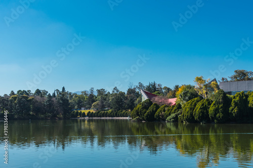 A beautiful view of a lake on a sunny day. A view of Bosque de Chapultepec, the biggest park in Mexico City and one of the biggest city parks in the world