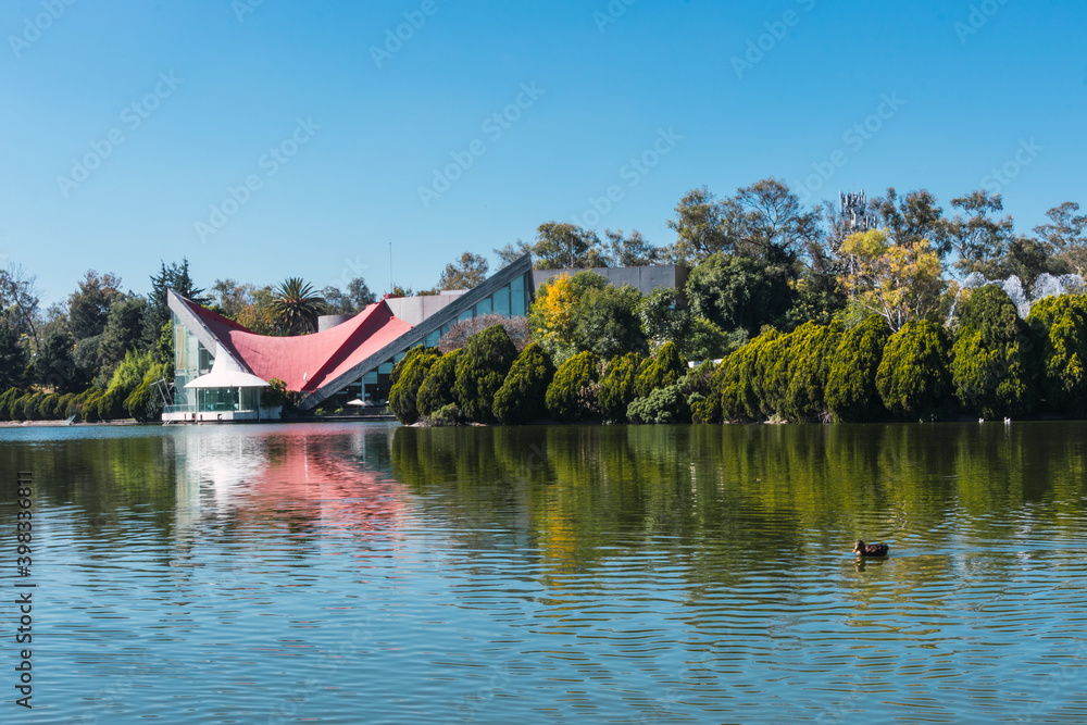 A beautiful view of a lake on a sunny day. A view of Bosque de Chapultepec, the biggest park in Mexico City and one of the biggest city parks in the world A beautiful view of a lake on a sunny day. A view of Bosque de Chapultepec, the biggest park in Mexico City and one of the biggest city parks in the world