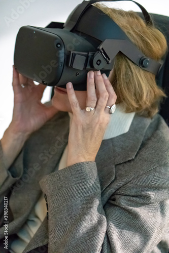Grodno  Belarus  June 01.2020  An adult woman wearing virtual reality glasses. Using VR technologies in everyday life. Introduction of augmented reality  science and technology of the future in life.