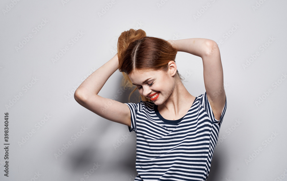 Pretty woman in striped t-shirt emotions hand gesture Pretty woman in striped t-shirt emotions hand gesture