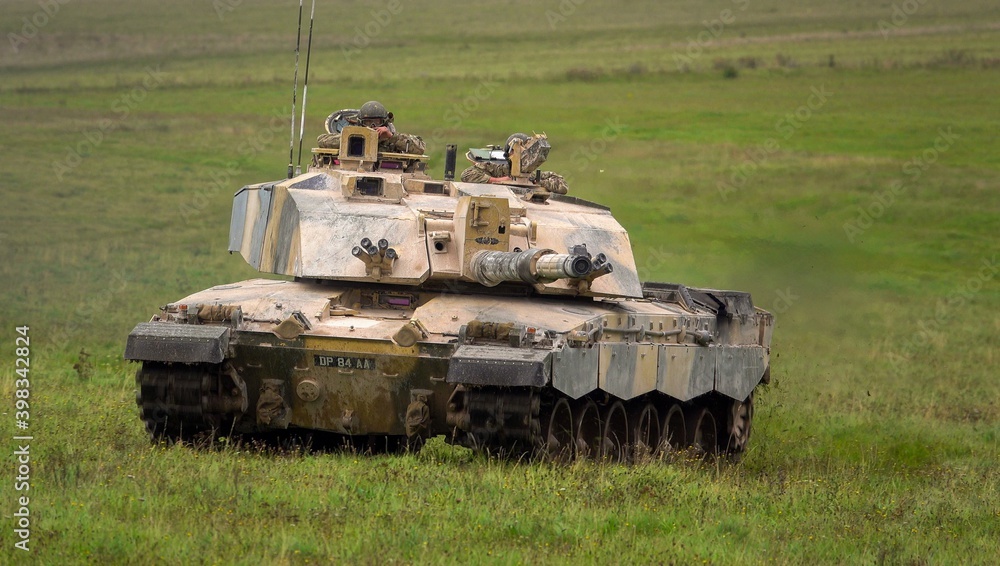 Fototapeta premium Action shot of a British army Challenger 2 FV4034 Main Battle Tank on a military exercise, gun aiming toward camera, Salisbury Plain, UK 
