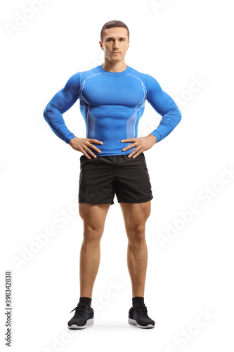 Full length portrait of muscular man in sportswear posing