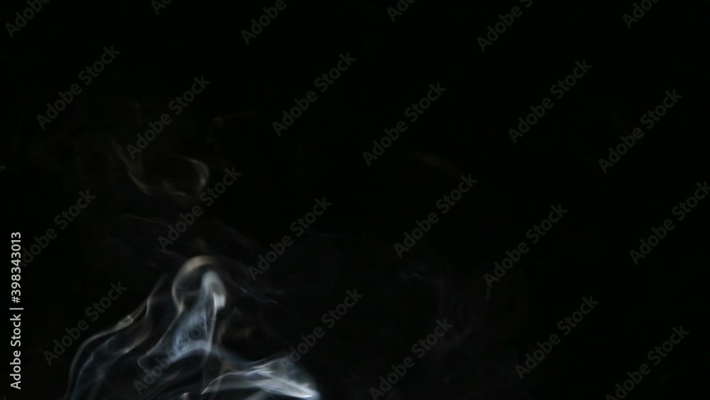 The movement of abstract puffs of smoke on a black background. The movement of abstract puffs of smoke on a black background.