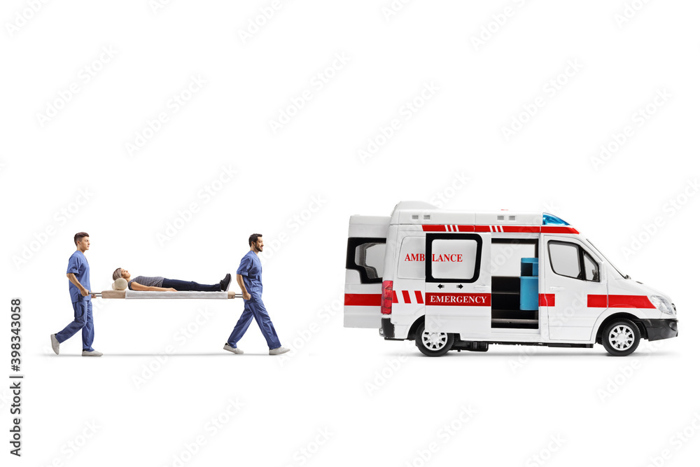 Medical workers carrying a stretcher with a female patient into an ambulance van