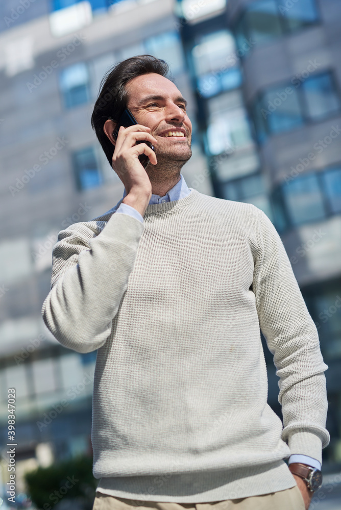Single casual male chats on his mobile, walking outside Single casual male chats on his mobile, walking outside