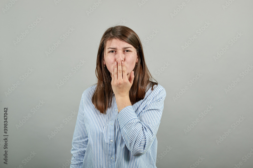 Sending sweet air kiss blowing red lips stretching hand for taking selfie demonstrate feelings. Young attractive woman, dressed blue shirt with brown eyes, brunette hair, grey background Sending sweet air kiss blowing red lips stretching hand for taking selfie demonstrate feelings. Young attractive woman, dressed blue shirt with brown eyes, brunette hair, grey background