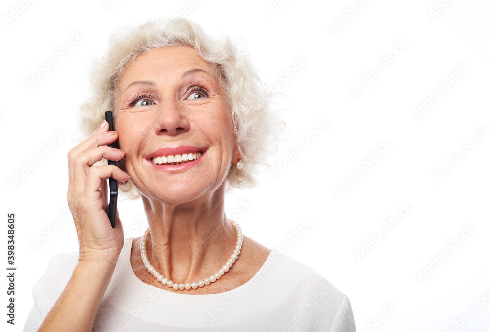 Cheerful successful sixty year elderly woman talking on the phone Cheerful successful sixty year elderly woman talking on the phone