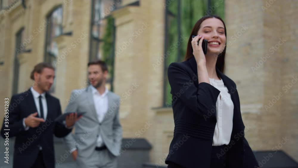 Smiling woman using mobile phone outdoors. Business people rushing work.