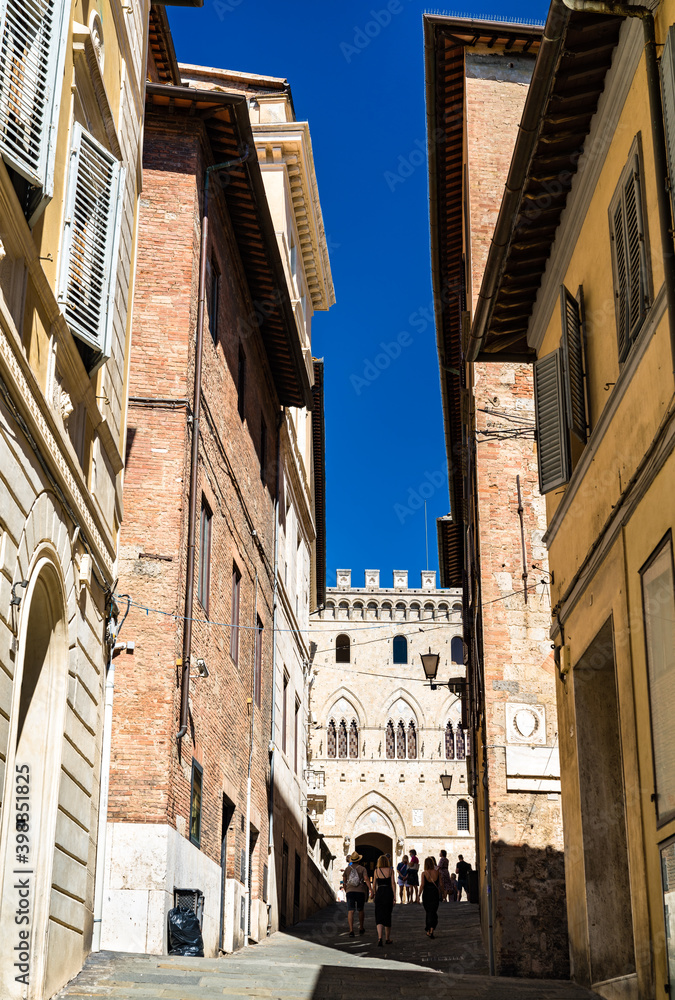 Narrow medieval street in Siena - Tuscany, Italy