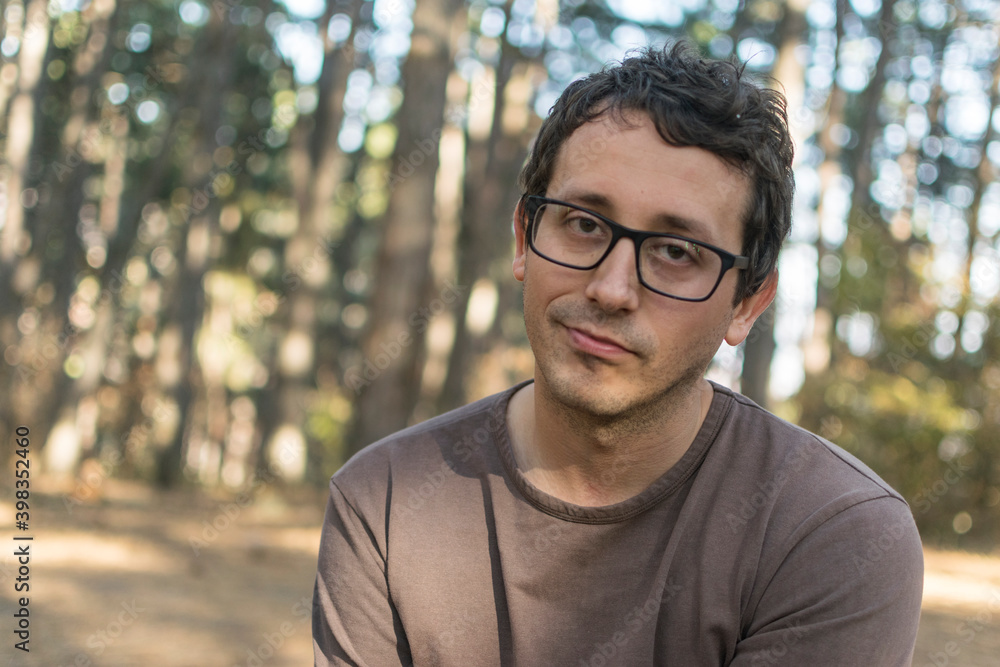 Portrait of young man with glasses in forest Portrait of young man with glasses in forest