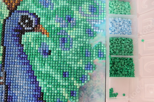 Diamond mosaic fragment picture close-up top view, handmade, hobby.