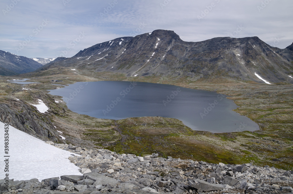 Big lake with snow and mountains in Jotunheimen, Norway