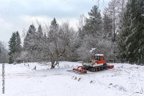 Snow groomer in a mountains at winter