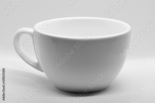 White cup on light background with selective focus