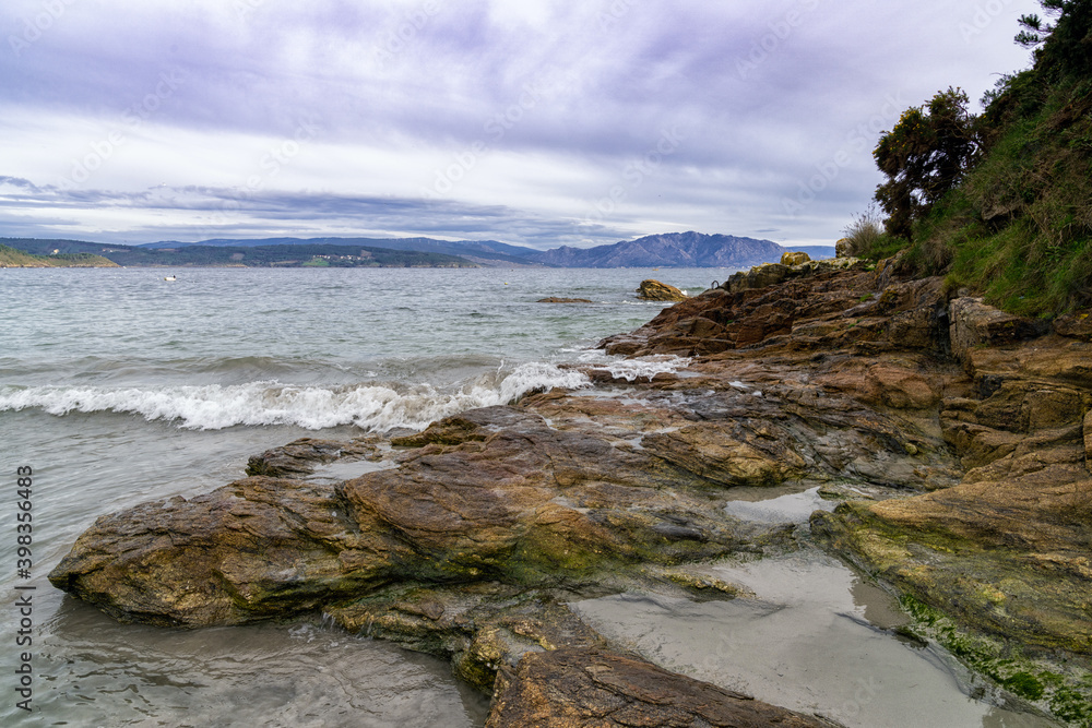 rocky beach with waves breaking on the western coast of Galicia