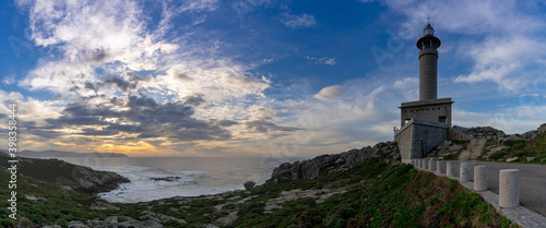 panorama view of the Punta Nariga lighthouse during a beautiful sunset on the coast of Galicia