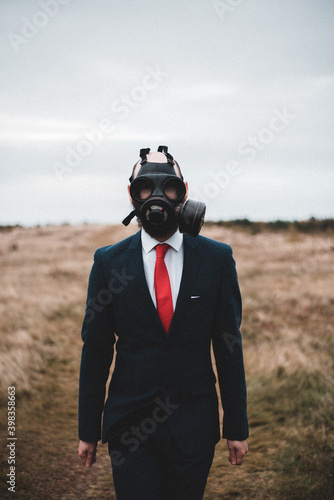 man wearing a gas mask in a field